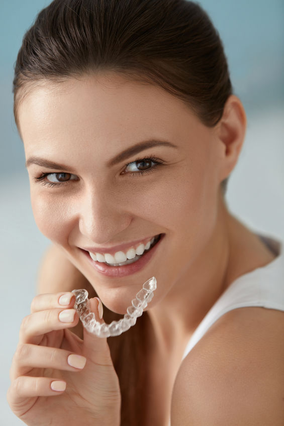 Woman holding a orthodontic aligner