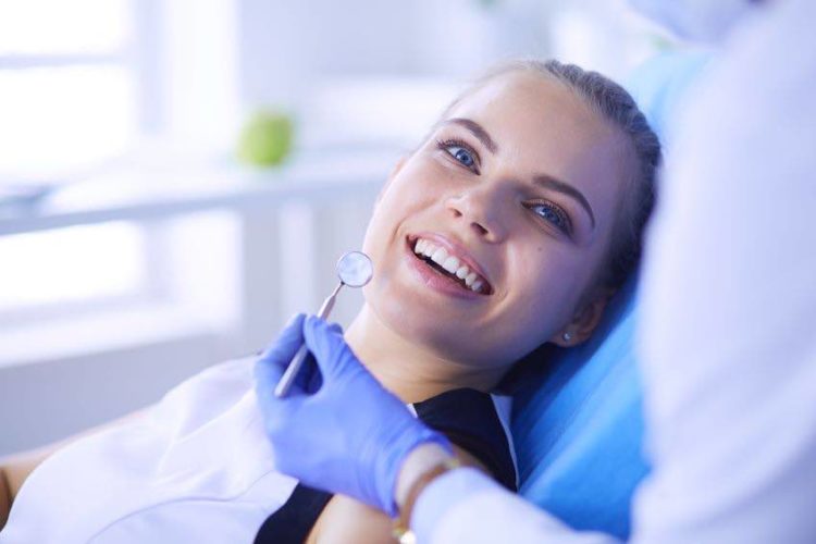 woman at orthodontists office smiling