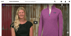 Screenshot of a Youtube video of a woman showing off a purple Patagonia fleece.