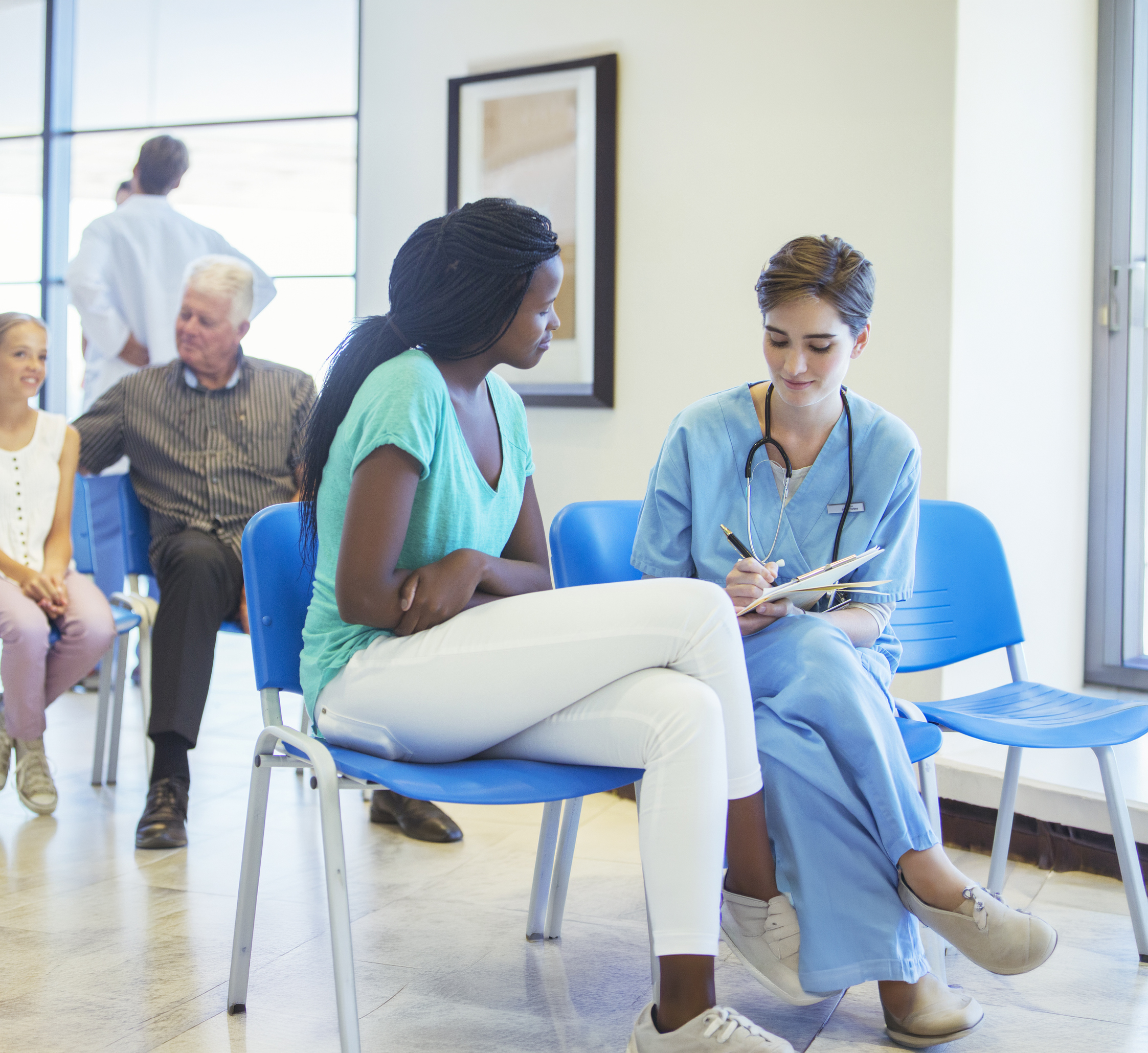 Nurse And Patient Talking In Hospital