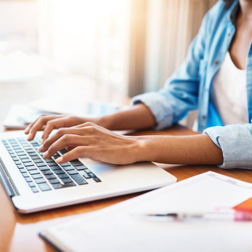 Putting in some hard work over the weekend Shot of an unrecognizable young woman working on her laptop at home